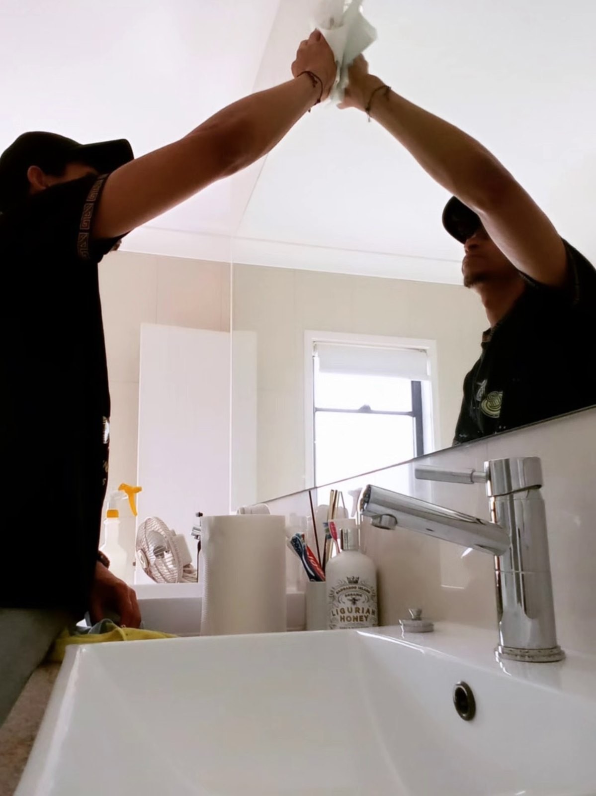 Ubuntu team member carefully wiping a bathroom mirror