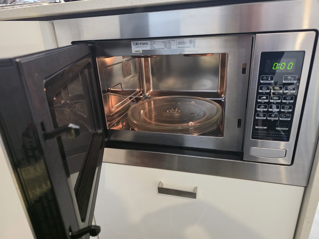 Open microwave showing the interior and glass turntable