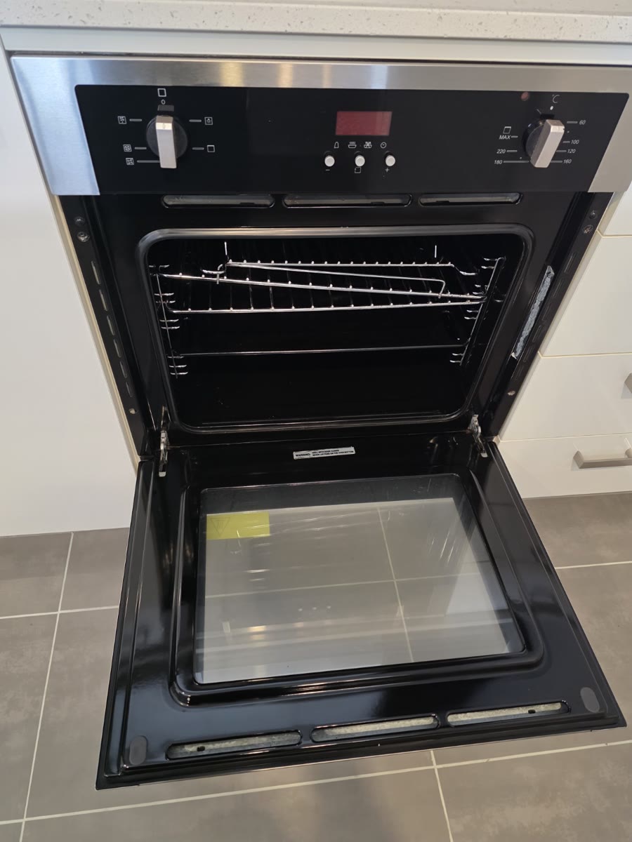Clean open oven with racks and inner door glass