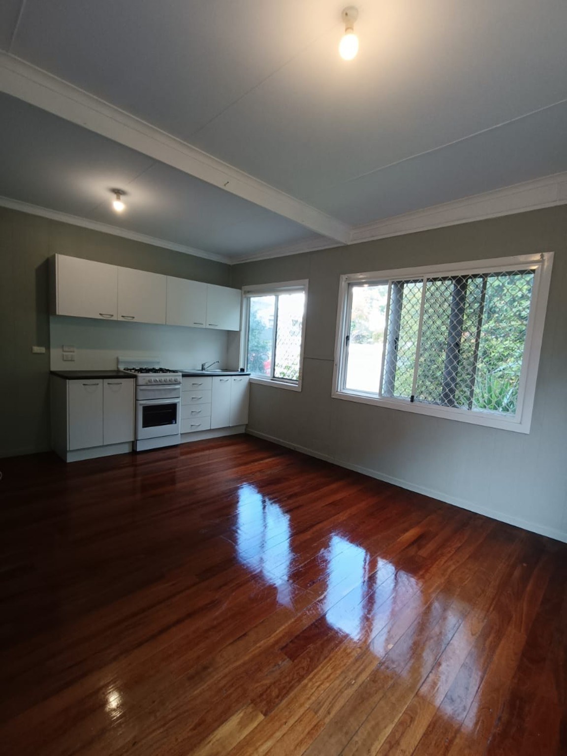 Gas cooktop, oven and white kitchen cabinetry